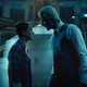 Eleven and Dr. Brenner give each other a hard stare in front of the lab's isolation tank.